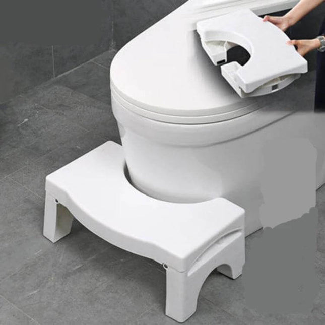 Non-Slip Toilet Foot Stool Foldable For Kids, Easy Squat Support — white foldable non-slip toilet stool placed at base of toilet for child and elderly support