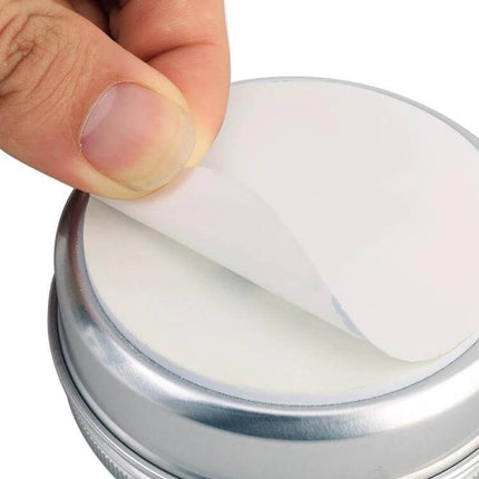 Non-Toxic Mouse Repeller For Home Use Protects Cables - close-up of a hand peeling adhesive lid from canister showcasing plant-based scent disc