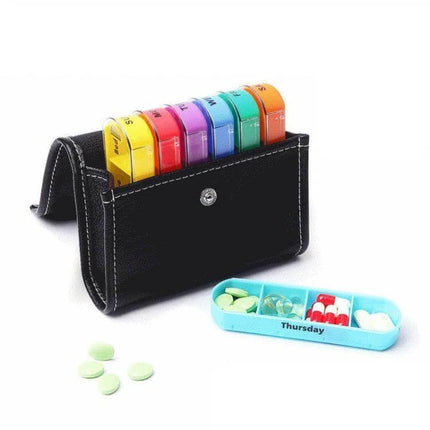 Notebook-Style 28-Compartment Portable Pill Box With Leather Bag showing seven detachable colorful 4-compartment daily boxes in a black leather binder