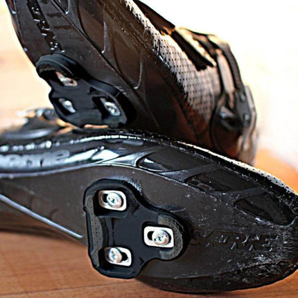 Road Bike Cleats Self Locking 2 Pack For Clip In Shoes — black nylon 6-degree float cleats mounted on road cycling shoes, lightweight 0.9 oz each