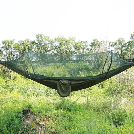 Portable Outdoor Camping Nylon Parachute Hammock 250x120cm with built-in mosquito net suspended between trees in grassy campsite