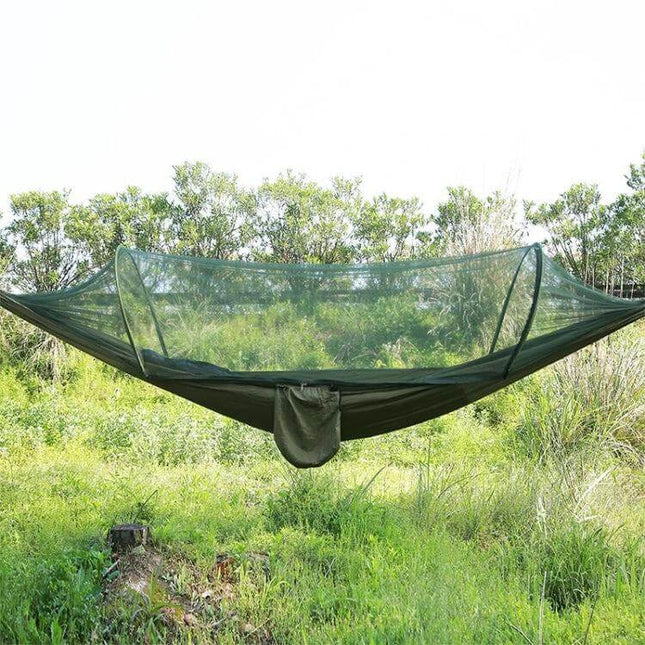 Portable Outdoor Camping Nylon Parachute Hammock 250x120cm with built-in mosquito net suspended between trees in grassy campsite