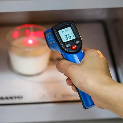 Portable Infrared Thermometer for Contactless Checks measuring candle surface temperature with digital display reading 36.7°C