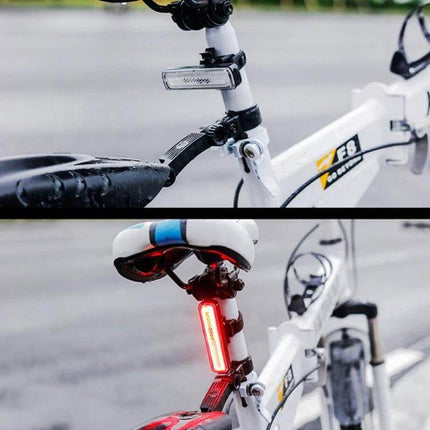 Rainbow Bike Tail Light USB Rechargeable For Night Riding mounted on white urban bike seatpost, compact PC housing rainbow finish, USB rechargeable rear safety light
