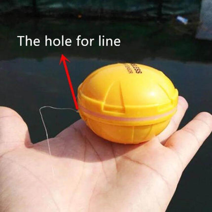 Bluetooth Fish Detector With 125KHz Sonar For iOS And Android - yellow handheld floatable sonar unit with line hole shown on palm