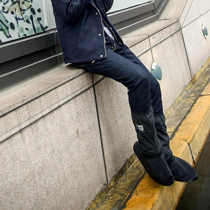 Waterproof and Snowproof Rain Shoes for Hiking and Cycling shown worn over jeans on a rainy urban curb to keep feet dry and secure