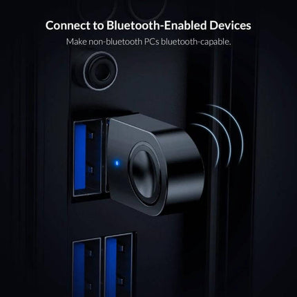 Orico Bluetooth Adapter for Easy Device Connectivity compact USB dongle plugged into PC enabling wireless headphones and speakers