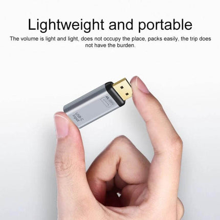 Versatile USB-C to HDMI Adapter for Screen Mirroring and Charging - compact plug-and-play HDMI dongle shown between fingers, supports charging