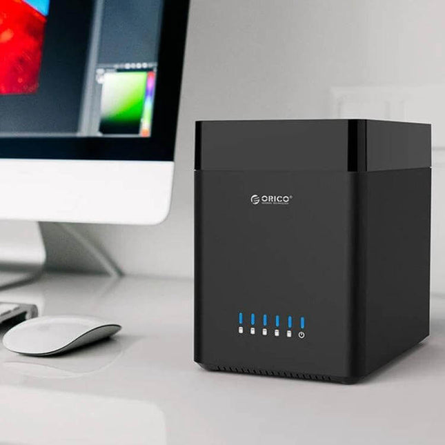 ORICO 5-Bay USB 3.0 Enclosure for 3.5-Inch Hard Drives on desk beside monitor, compact black multi-drive storage solution