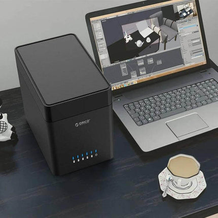 ORICO 5-Bay USB 3.0 Enclosure for 3.5-Inch Hard Drives on desk next to laptop, showing compact black multi-bay storage solution for video editors and small businesses