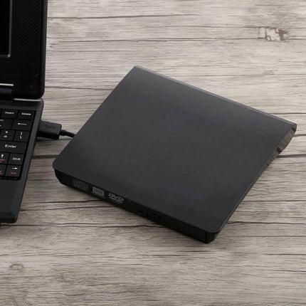 Portable USB 3.0 External DVD-RW Drive for Laptops and Desktops slim black drive connected to laptop for reading and writing CDs and DVDs