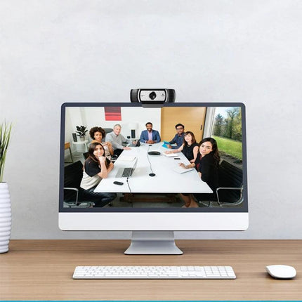 Logitech C930C HD Webcam with Protective Cover for Video Calls mounted on monitor capturing a remote team meeting in 1080p HD