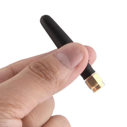 Compact 5cm GSM Antenna with SMA Male Connector for Wireless Devices in hand showing compact size and SMA male connector