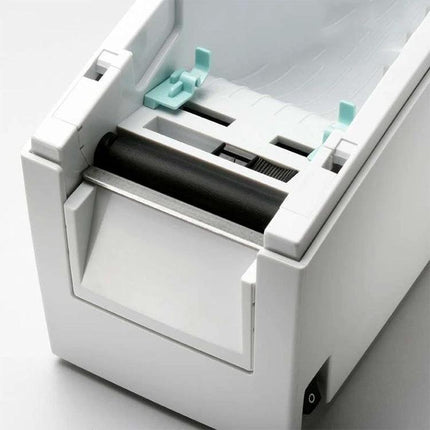 GODEX EZ-DT2 Thermal Label Printer for Barcode Applications producing clear barcode labels in a warehouse setting, close-up of label feed mechanism