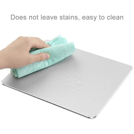 Double-Sided Circle Shaped Aluminum Desk Mouse Pad being wiped clean, showing water beading and easy-to-clean aluminum surface