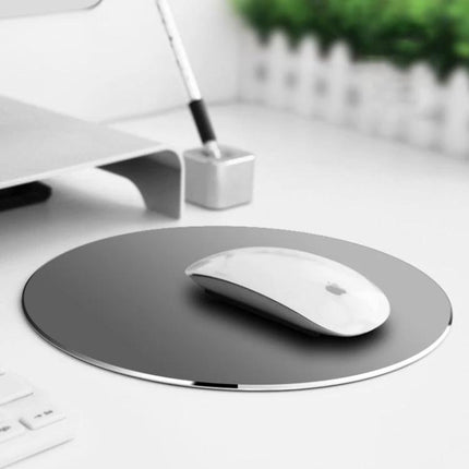 Double-Sided Circle Shaped Aluminum Desk Mouse Pad showing sleek round aluminum surface with PU leather, white wireless mouse on top for office and gaming use
