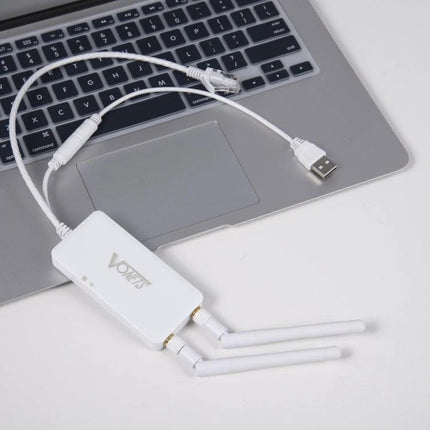 Vonets VAP11S Mini Wireless Bridge for Extending Networks white unit with three antennas beside laptop, USB and Ethernet cables