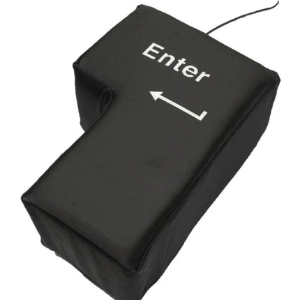 Big Enter Button USB Pillow for Relaxing at Your Desk - Black soft USB-powered Enter key pillow on desk, angled view showing arrow and cable