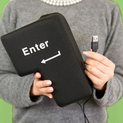 Big Enter Button USB Pillow for Relaxing at Your Desk - Black held in hands showing USB plug and Enter key design