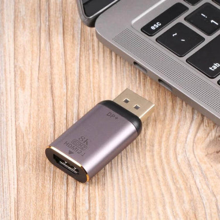 HDMI to DisplayPort Adapter for Computer Video Connections compact adapter next to laptop for audio and video transmission