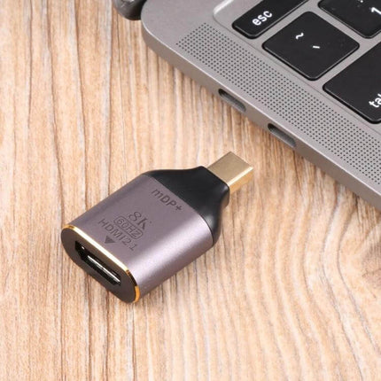 HDMI to Mini DisplayPort Adapter for Video and Audio Links – compact gold-tipped adapter beside laptop for audio and video connection
