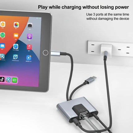 NK-1056Pro Adapter for Everyday Device Connectivity and Charging connected to tablet, Ethernet, charging and audio cables in use