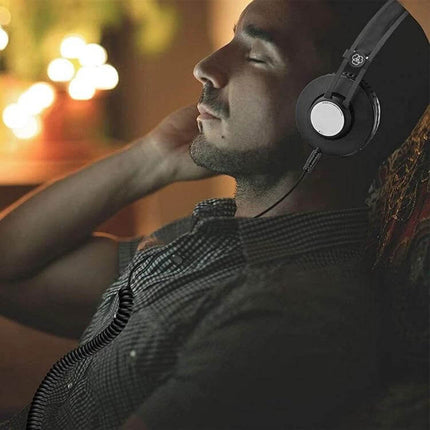 Audio Replacement Cable for AKG Q701 and Pioneer HDJ-2000 attached to over-ear headphones with relaxed listener enjoying music