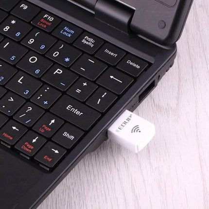 EDUP Mini Dual-Band Wireless USB Adapter for Laptops and PCs plugged into a laptop USB port showing compact white dongle for dual-band WiFi