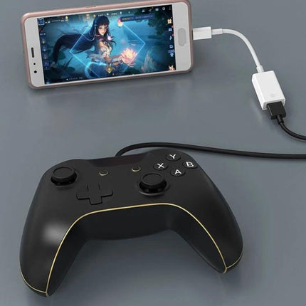USB-C Adapter for Connecting Devices to Phones Daily — phone connected to game controller and USB via plug-and-play adapter