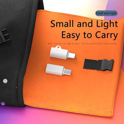 Compact USB Adapter for Everyday Device Connections at Home – small white USB-C adapter on orange mat, easy to carry for charging and data transfer