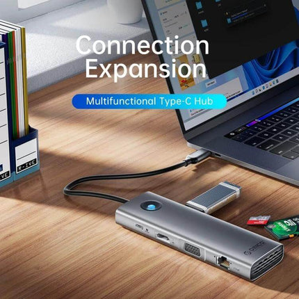 Orico 8-in-1 USB-C Docking Station for Versatile Connectivity slim gray hub connected to laptop showing Ethernet, HDMI, USB and SD card slots