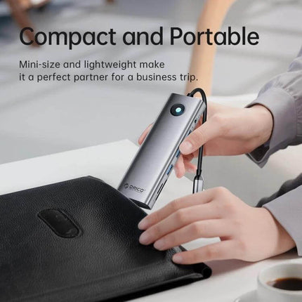 Orico 8-in-1 USB-C Docking Station for Versatile Connectivity shown compact and portable being placed into a briefcase for business travel