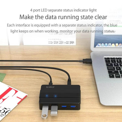 ORICO 4-Port USB 3.0 Hub for Smartphones and Tablets on desk connected to laptop showing four devices and LED status lights