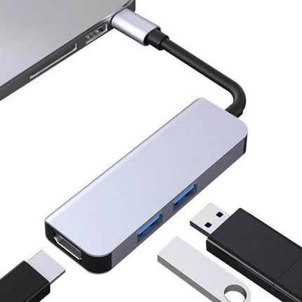 Compact USB-C Docking Station for Expanding Laptop Ports connected to laptop with USB drives and monitor cable