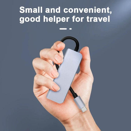 Compact USB-C Docking Station for Expanding Laptop Ports compact travel hub held in hand, USB-C cable and multiple ports visible