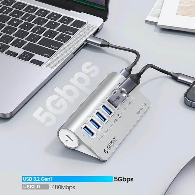 ORICO 7-Port USB Hub for Connecting Multiple Devices shown connected to a laptop with multiple peripherals and 5Gbps transfer speed