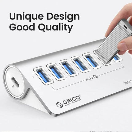 Orico Aluminum 7-Port USB Hub for Device Connections — silver aluminum hub with seven USB ports and flash drive inserted