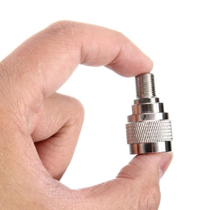 F-Type Female to UHF Male Connector for Antennas and Cables held between fingers, nickel-plated adapter for TV antenna and radio cable connections