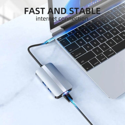 BYL 6-In-1 USB-C Docking Station for Multiple Ports connected to laptop showing Ethernet and USB ports in compact aluminum design
