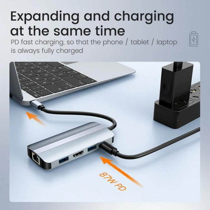 USB-C 9-in-1 Multifunctional Docking Station for Versatile Connectivity shown connected to a laptop charging and expanding ports with 87W PD cable