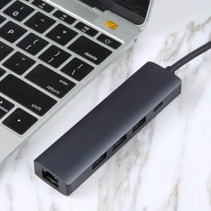BYL 5-in-1 USB-C Docking Station for Device Connectivity connected to laptop showing USB, Ethernet and charging ports