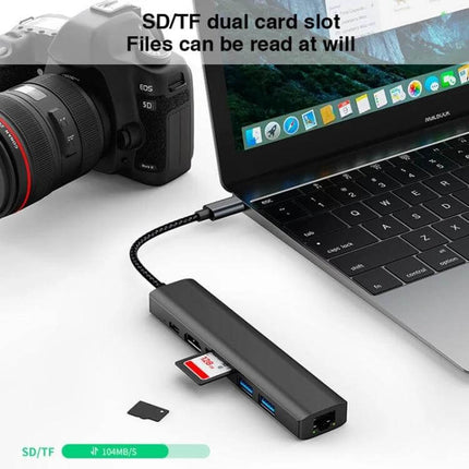BYL 7-in-1 USB-C Docking Station for Device Connectivity Solutions connected to laptop with SD card, USB ports and RJ45 for travel and office
