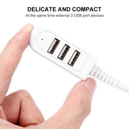Compact USB Hub for Everyday Device Connections at Home and Travel - white 3-port compact USB hub held between fingers for charging and data transfer