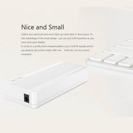 Tenda 8-Port Network Switch for Connecting Home Devices compact white switch beside keyboard, small plug-and-play Ethernet hub