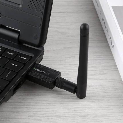 EDUP Dual Band Wireless USB Adapter for WiFi and Bluetooth Connectivity plugged into a laptop USB port with external antenna