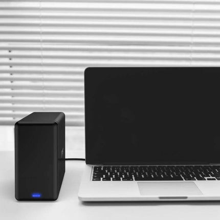 Orico 2-Bay External Hard Drive Enclosure for SATA HDDs shown connected to a laptop on a desk, tool-free dual-bay desktop storage solution