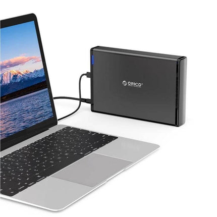 ORICO 8TB USB-C HDD Enclosure for Portable Data Storage black vertical aluminum enclosure connected to a laptop via USB-C for backups and transfers