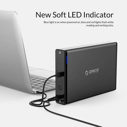 ORICO 8TB USB-C HDD Enclosure for Portable Data Storage vertical aluminum alloy 3.5-inch SATA external drive with soft LED indicator connected to laptop