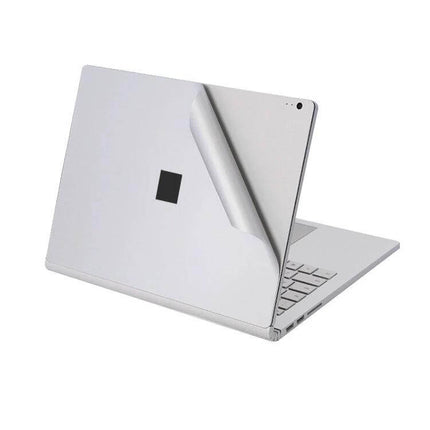 Protective Film Sticker Set for Microsoft Surface Book 2 15-Inch showing peel-off silver back cover protecting laptop exterior
