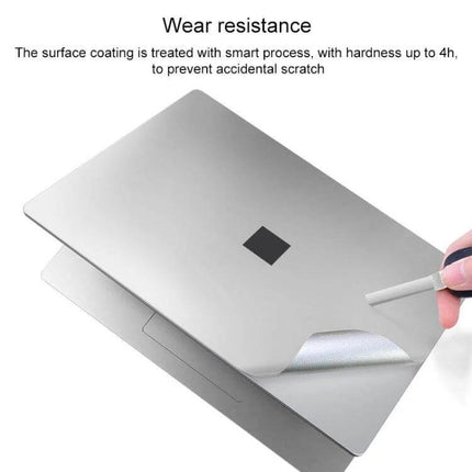 Protective Film and Sticker Set for Microsoft Surface Laptop 3, 13.5 Inch applied to silver laptop lid shown being peeled for scratch protection